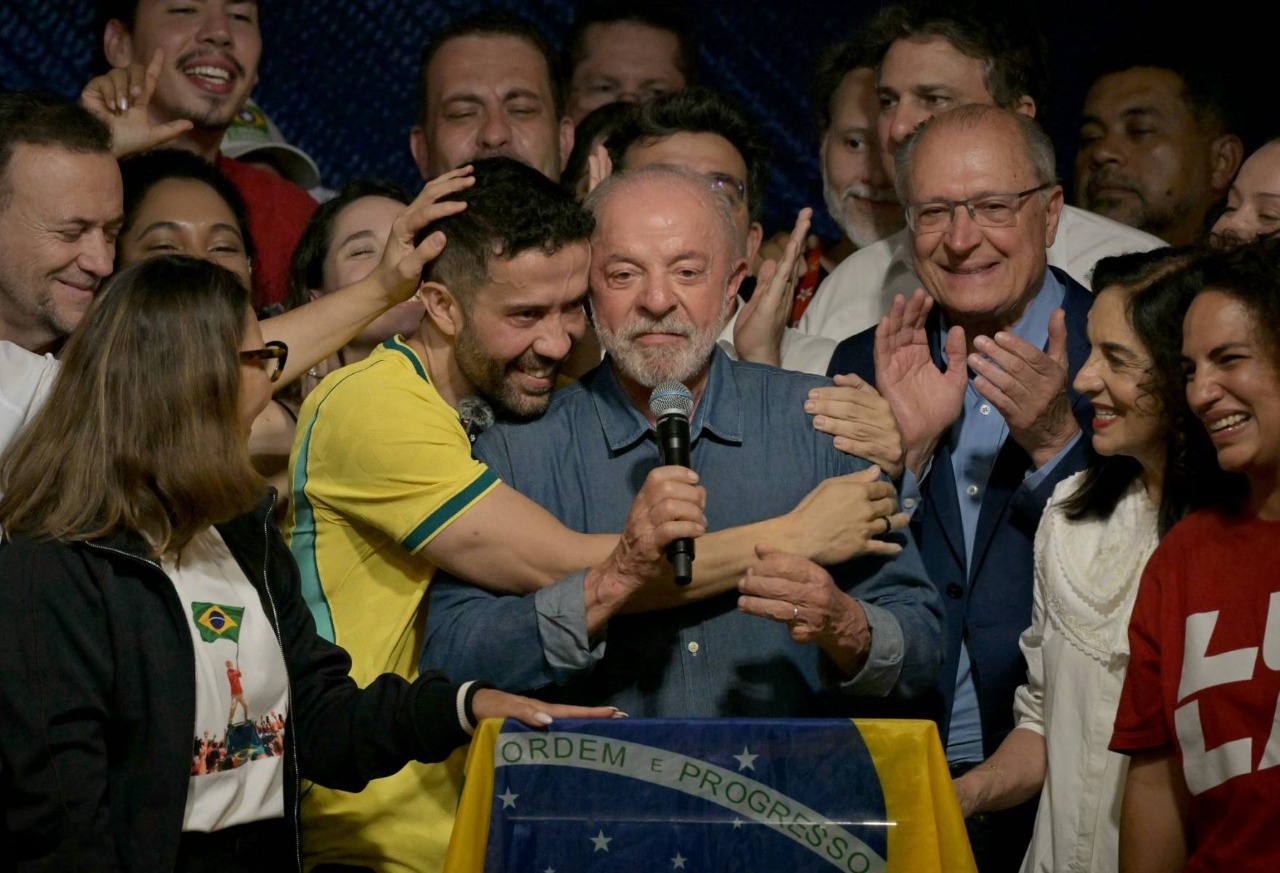 El presidente de Brasil y candidato a la reelección por el Partido de los Trabajadores (PT), Luiz Inácio Lula da Silva (centro), reacciona junto a su esposa, la primera dama Rosângela da Silva (izquierda); el diputado federal por Minas Gerais, André Janones (segundo desde la izquierda) —creador del canal de WhatsApp «Ejército de Lula» para movilizar a sus partidarios—; y el vicepresidente Geraldo Alckmin (tercero desde la derecha), tras conocerse los primeros resultados de la segunda vuelta de las elecciones presidenciales, en São Paulo, Brasil, el 25 de octubre de 2026. Lula da Silva protagonizó una remontada espectacular el 25 de octubre de 2026, al asegurarse la victoria electoral frente al senador de derecha Flávio Bolsonaro, quien lo había superado ampliamente en la primera vuelta.